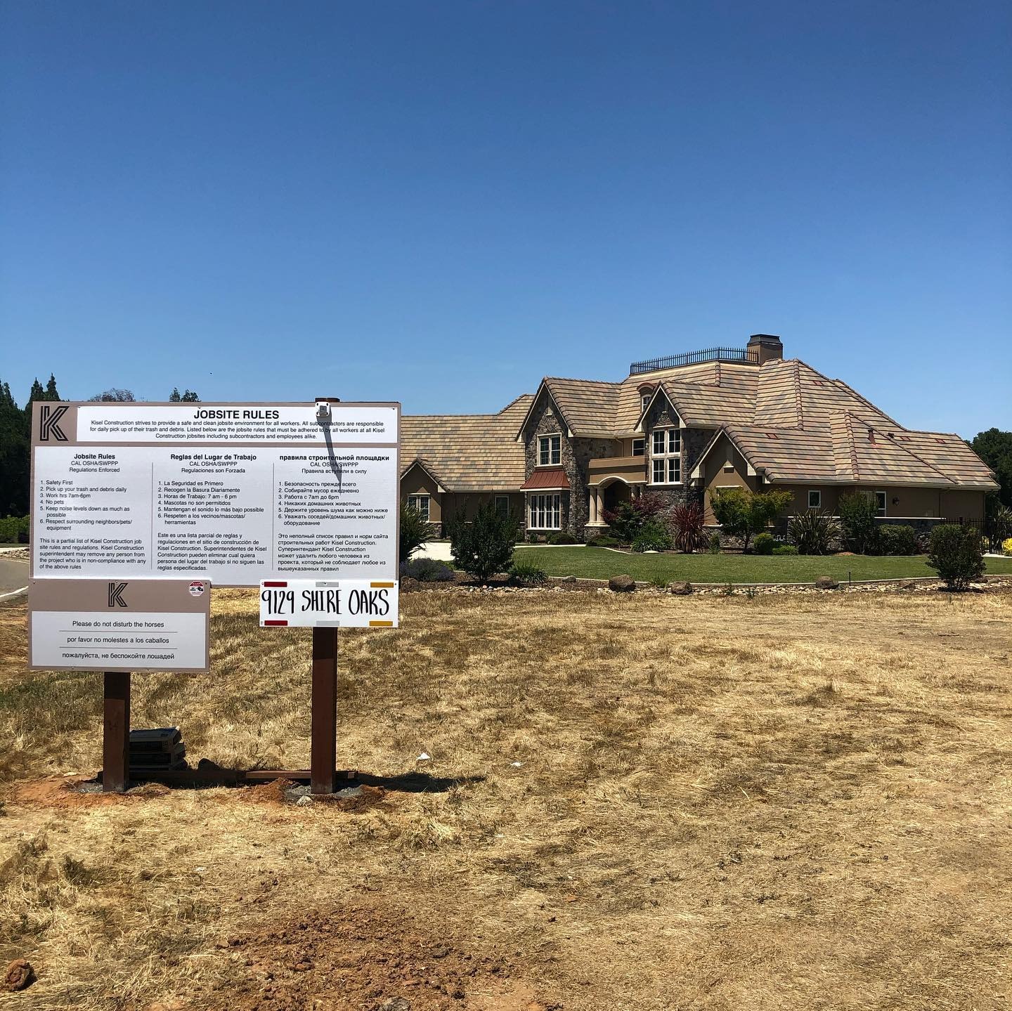 A jobsite notice board posted at the front of a lot before work begins.