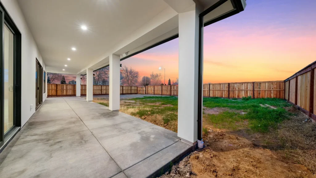 The covered patio at dusk, looking out across the yard.