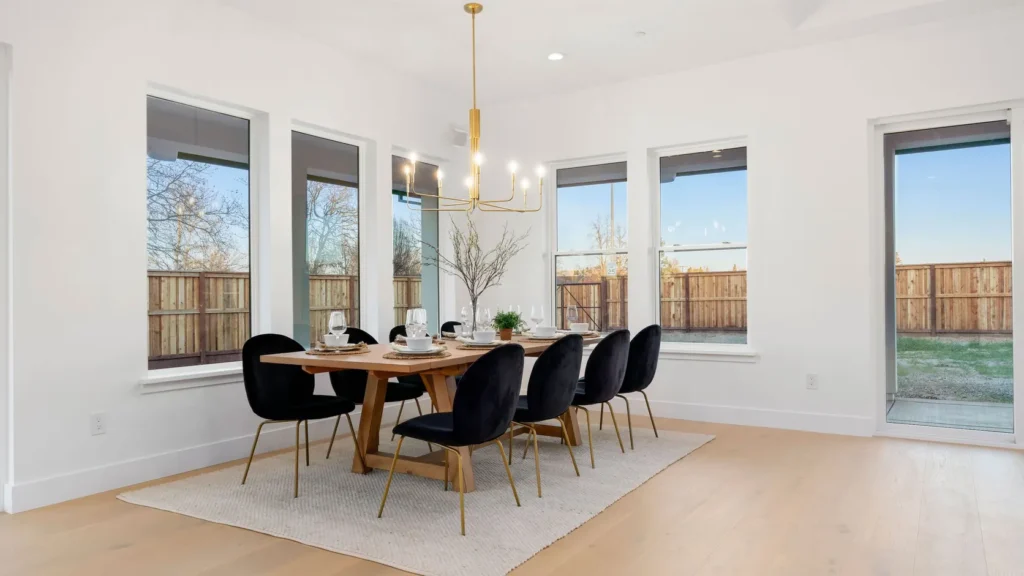 The dining room, framed by windows on three sides.