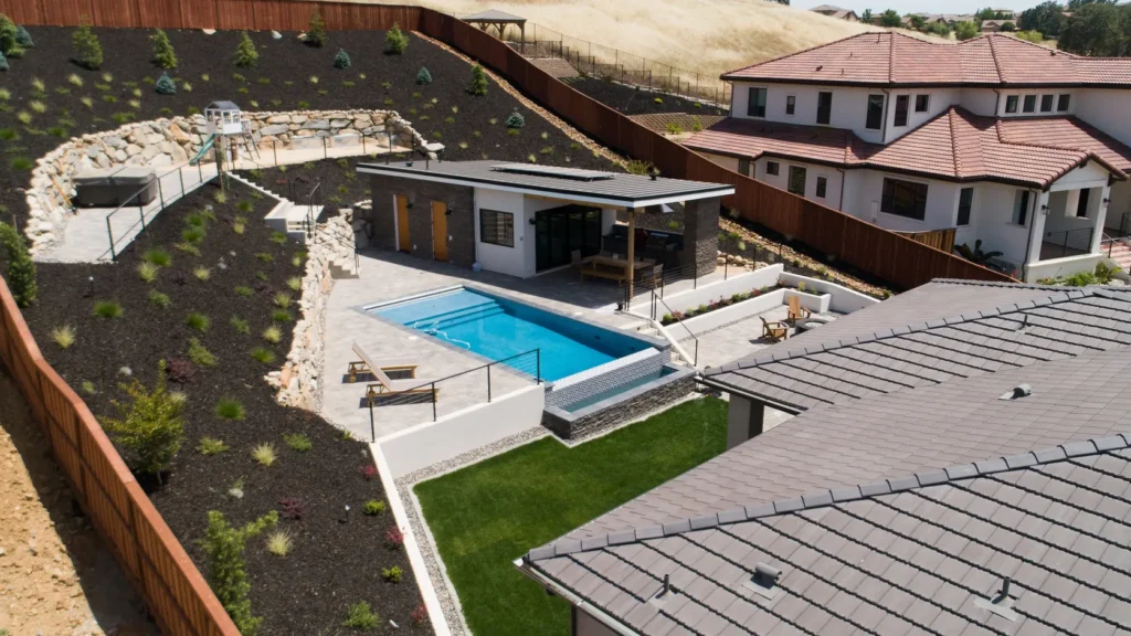 The finished pool house in its hillside setting.