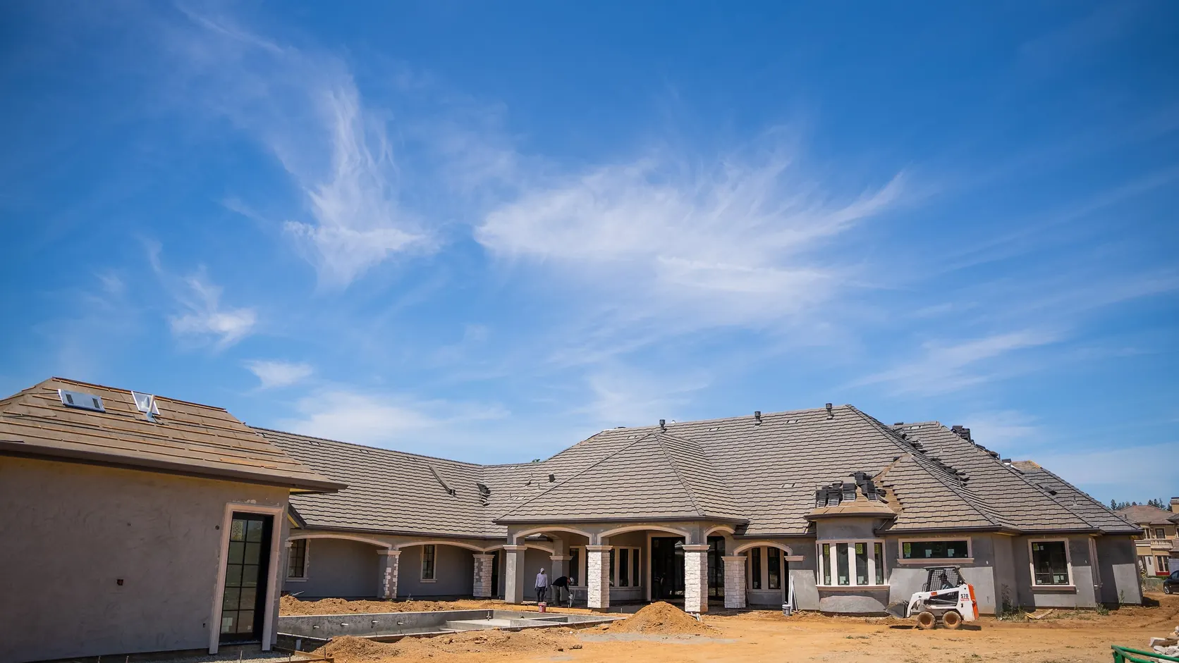 The ranch style elevation under construction, roof tiling complete.