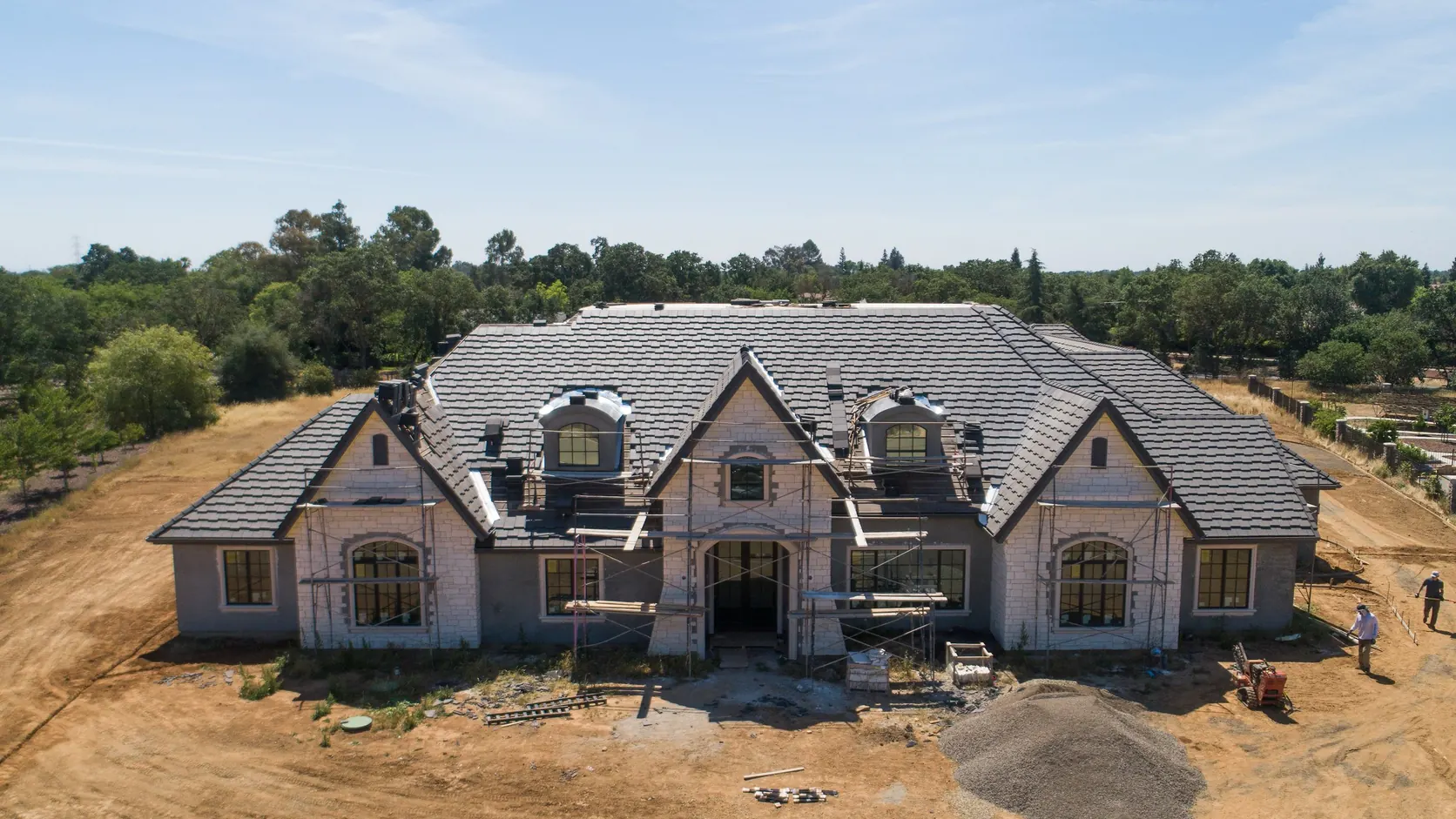 The house from above, mid construction on its cleared lot.
